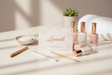 create a photo of a Lunali Gift Card on top of a manicure table surrounded by some nail products. Make it girly and pink in a minimalist way. 