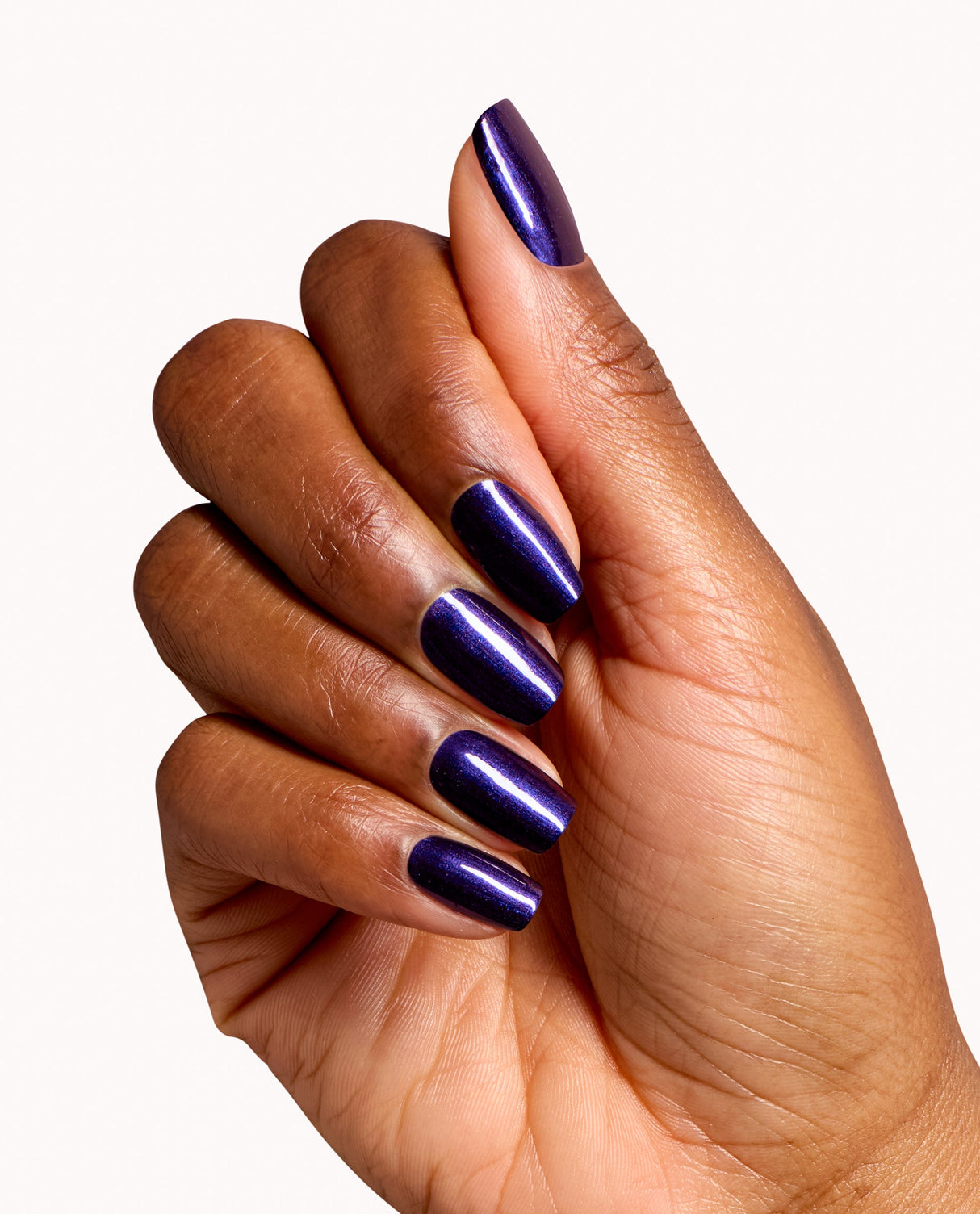 Hand displaying glossy deep purple metallic gel manicure using OPI Don't Over Ink It