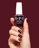 Hand holding OPI Every Month is Oktoberfest gel polish bottle