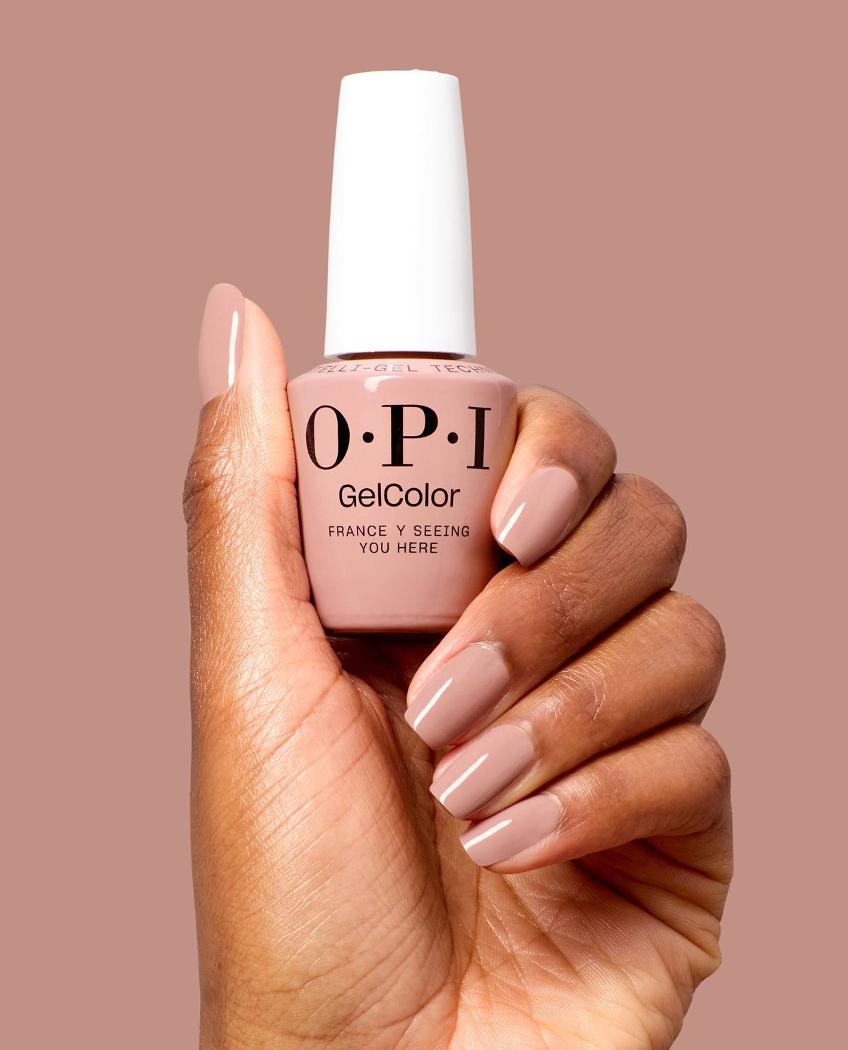 Hand holding OPI France-y Seeing You Here gel polish bottle