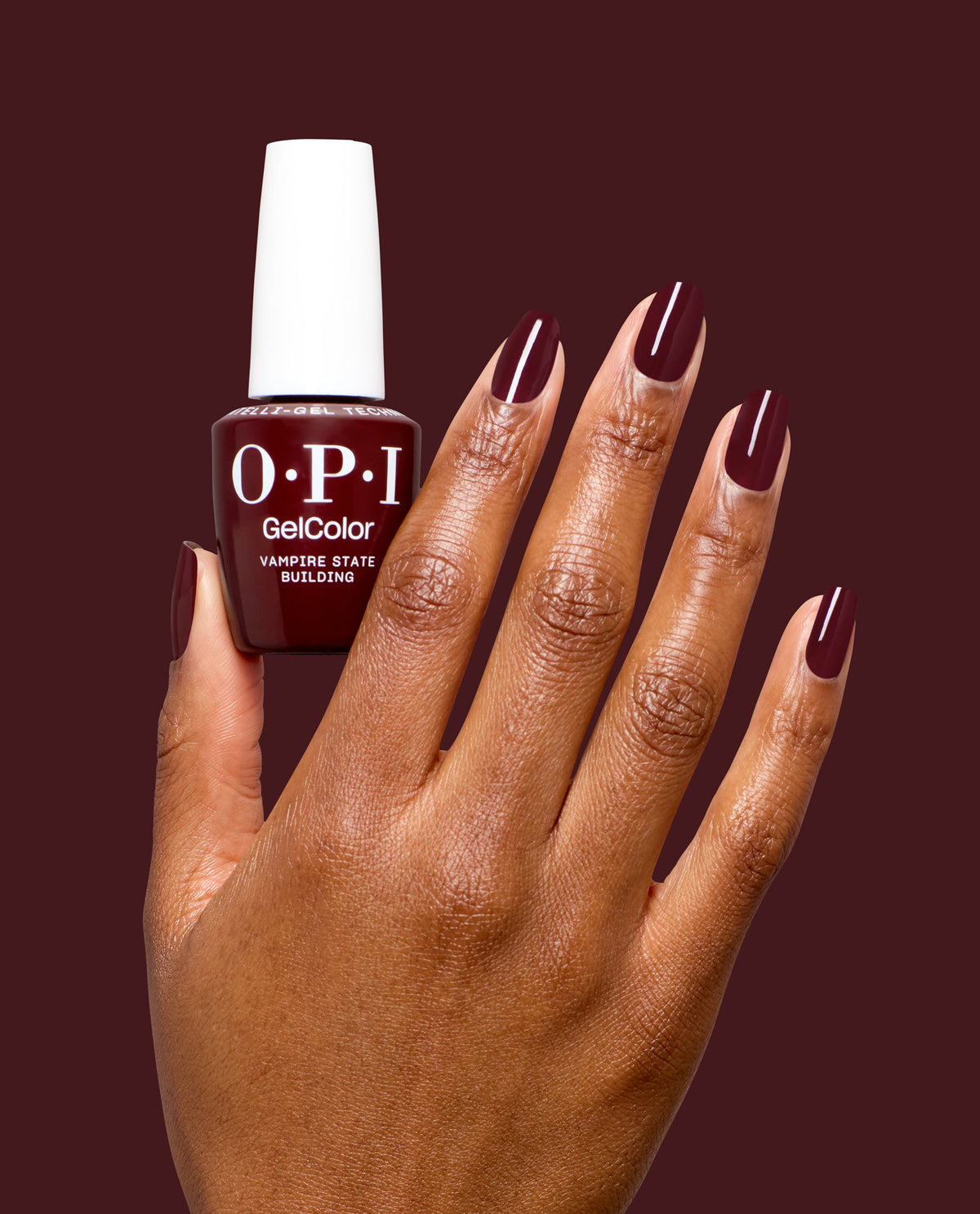Hand holding OPI Vampire State Building gel polish bottle